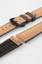 Golden brown textile-effect watch strap with brown rubber backing and a black buckle, shown in separate sections on a white background. Features a woven-look surface, brown edges, and a patterned rubber underside.