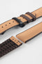 Golden brown textile-effect watch strap with brown rubber backing and a black deployment clasp, shown in separate sections on a white background. Features a woven-look surface, brown edges, and a patterned rubber underside.