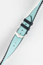 Ice blue textile-effect watch strap with a silver-tone buckle, shown fastened on a white background. Features black edges, a woven-look texture, and a black rubber backing.