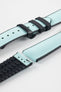 Ice blue textile-effect watch strap with black rubber backing and a black deployment clasp, shown in separate sections on a white background. Features a woven-look surface, black edges, and a patterned rubber underside.