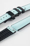 Ice blue textile-effect watch strap with black rubber backing and a black deployment clasp, shown in separate sections on a white background. Features a woven-look surface, black edges, and a patterned rubber underside.