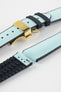 Ice blue textile-effect watch strap with black rubber backing and a gold-tone deployment clasp, shown in separate sections on a white background. Features a woven-look surface, black edges, and a patterned rubber underside.