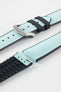 Ice blue textile-effect watch strap with black rubber backing and a brushed silver-tone buckle, shown in separate sections on a white background. Features a woven-look surface, black edges, and a patterned rubber underside.