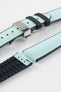 Ice blue textile-effect watch strap with black rubber backing and a silver-tone deployment clasp, shown in separate sections on a white background. Features a woven-look surface, black edges, and a patterned rubber underside.