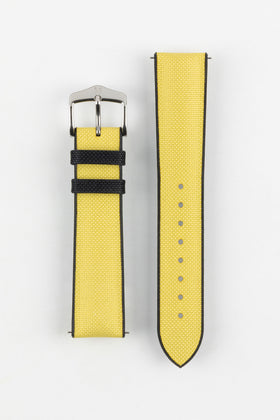 A Hirsch Arne Yellow Animal-Free Sailcloth Effect Performance Watch Strap is displayed on a white background, showcasing the strap's full length and a silver pin buckle. The textured sailcloth-like material of the yellow strap is clearly visible, along with the black rubberized underside.