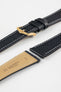 Black textured leather watch strap with a gold-tone buckle, shown with a beige leather underside and white contrast stitching.