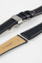Black leather watch strap with a stainless steel deployant clasp, shown with a beige leather underside and white contrast stitching.