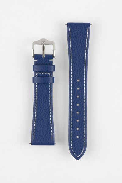 Product shot of a blue textured leather watch strap displayed against a white background, showing both sections separately: one with a polished silver-tone pin buckle and two keepers, and the other with a pointed tip and multiple adjustment holes, highlighting the white contrast stitching and fine grain texture.