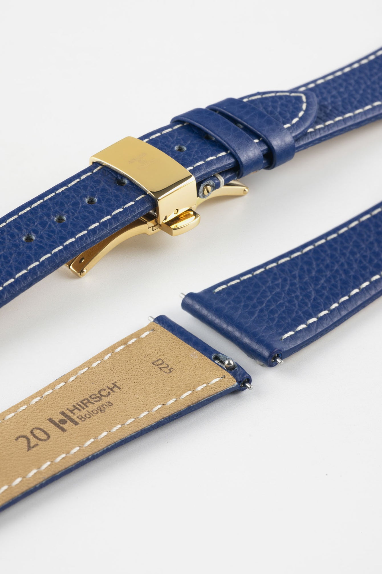 Blue leather watch strap with a golden deployant clasp, shown with a beige leather underside and white contrast stitching.