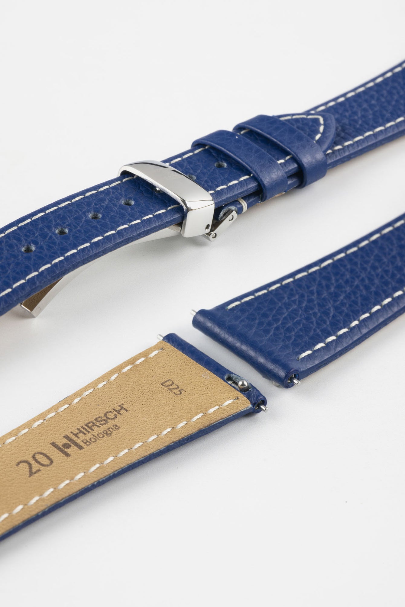Close-up product image of a blue textured leather watch strap with white contrast stitching, displayed against a white background, featuring a polished silver-tone folding clasp and two keepers, alongside separate strap sections with exposed spring bars and a beige underside stamped with partial text “20 HIRSCH Bologna.”