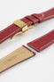 Burgundy leather watch strap with a golden deployant clasp, shown with a beige leather underside and white contrast stitching.