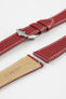 Close-up product image of a red textured leather watch strap with white contrast stitching, shown against a white background, featuring a polished silver-tone pin buckle and two keepers, alongside separate strap sections with visible spring bars and a beige underside stamped with partial branding text “20 HIRSCH.”