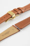 Gold brown leather watch strap with a golden deployant clasp, shown with a beige leather underside and white contrast stitching.