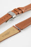 Gold brown leather watch strap with a stainless steel deployant clasp, shown with a beige leather underside and white contrast stitching.