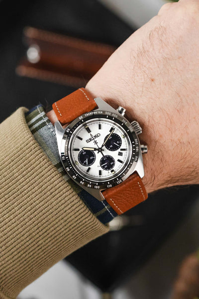 Seiko Prospex speedtimer panda chronograph fitted with gold brwn Hirsch bologna leather watch strap worn on wrist with jumper and shirt