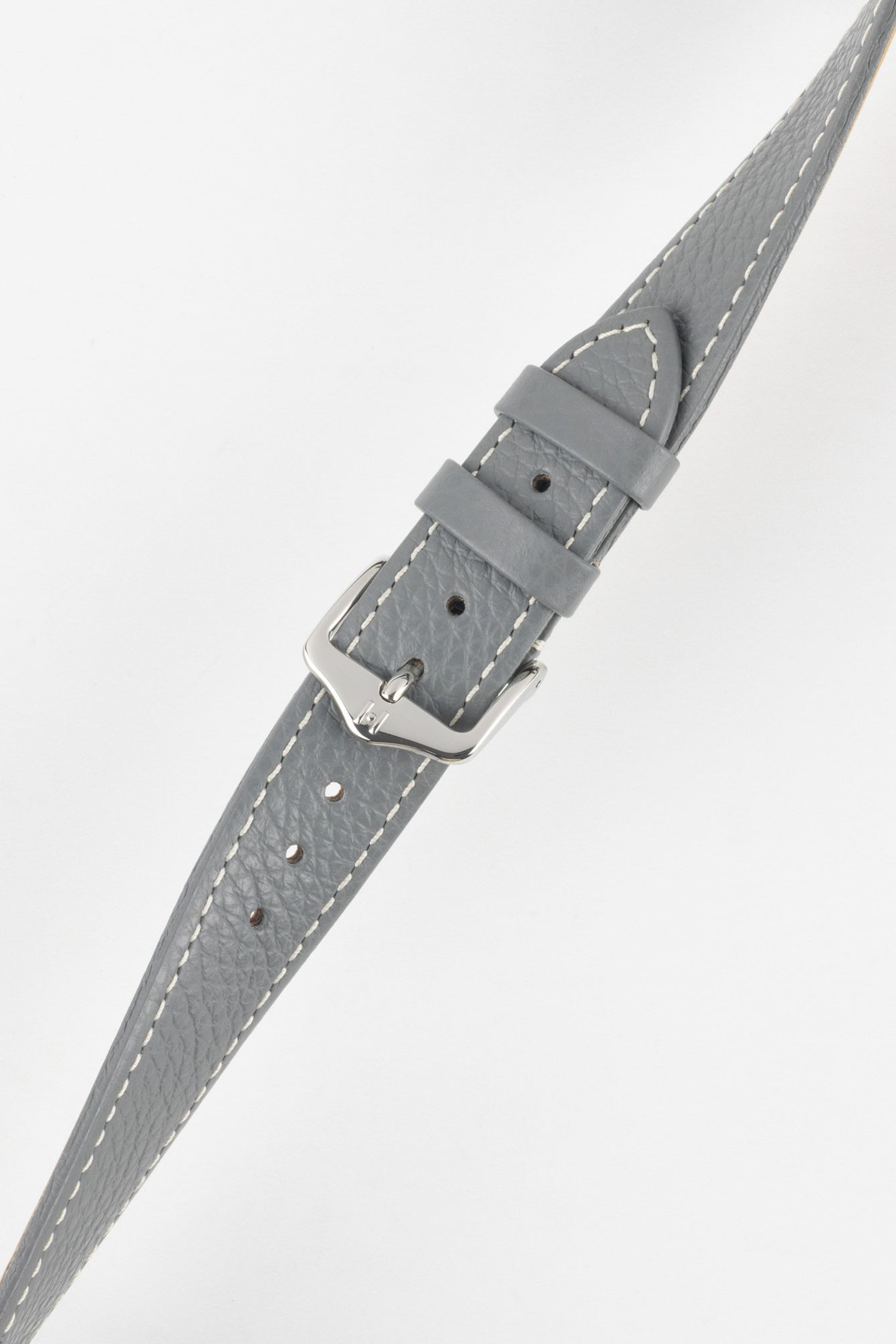 Close-up of a grey textured leather watch strap with white contrast stitching, featuring a polished silver-tone pin buckle and two keepers, with visible adjustment holes and a subtly grained finish against a white background.