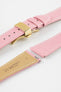 Close-up of a pink leather watch strap with white stitching and a gold-tone butterfly clasp, displayed open alongside separate strap pieces with exposed spring bars and a tan underside stamped with Hirsch Bologna branding, set against a clean white background.