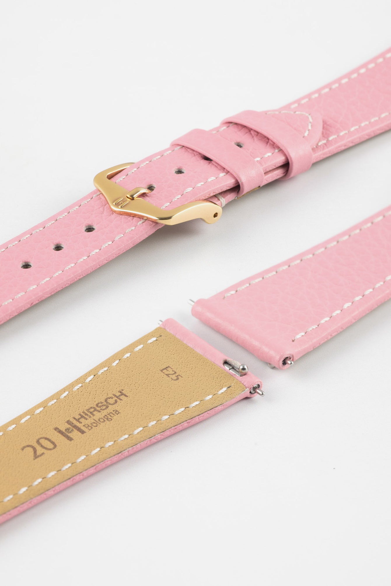 Close-up product image of a pink textured leather watch strap with white contrast stitching, displayed on a white background, featuring a polished rose gold-tone pin buckle and two keepers, alongside separate strap sections with exposed spring bars and a beige underside stamped “HIRSCH Bologna 20.”