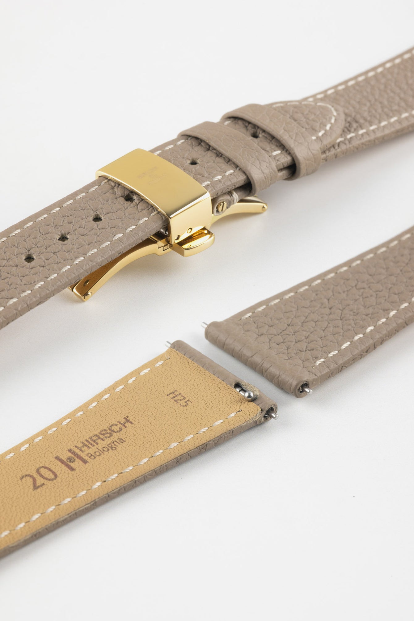 Taupe leather watch strap with a golden deployant clasp, shown with a beige leather underside and white contrast stitching.