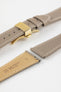 Taupe leather watch strap with a golden deployant clasp, shown with a beige leather underside and white contrast stitching.