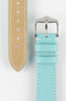 Close-up product image of a light turquoise-blue leather watch strap against a white background, showing the underside with multiple adjustment holes and beige lining on one section, and the other with a polished silver-tone pin buckle and two keepers, highlighting the white contrast stitching and fine textured grain.