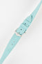 Close-up of a light turquoise-blue textured leather watch strap with white contrast stitching, featuring a polished silver-tone pin buckle and two keepers, with visible adjustment holes and a lightly grained finish against a white background.