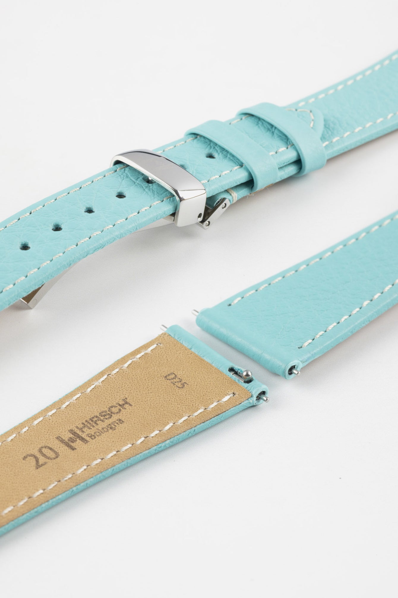 Close-up product image of a light turquoise-blue textured leather watch strap with white contrast stitching, displayed against a white background, featuring a polished silver-tone folding clasp and two keepers, alongside separate strap sections with exposed spring bars and a beige underside stamped with partial text “20 HIRSCH Bologna.”