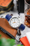 Hirsch Boston Blue watch strap paired with a Timex Indiglo watch on a leather watch pouch. High-quality watch accessory.