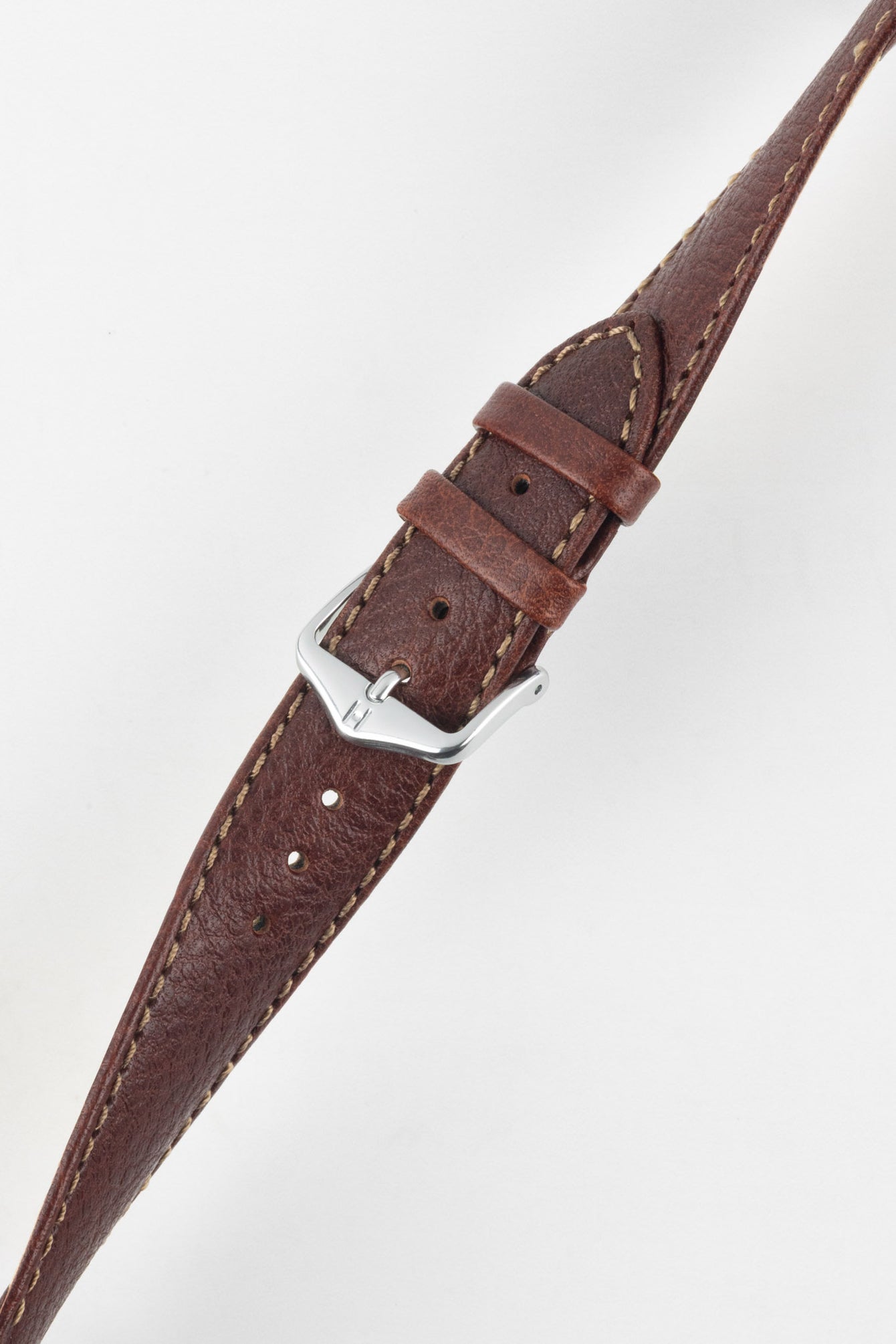 Angled shot of HIRSCH Forest brown leather watch strap showing the light stitching and polished silver buckle.