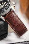 Close-up of a Seiko 5 Sports diver watch paired with a textured brown leather watch strap and stitching.