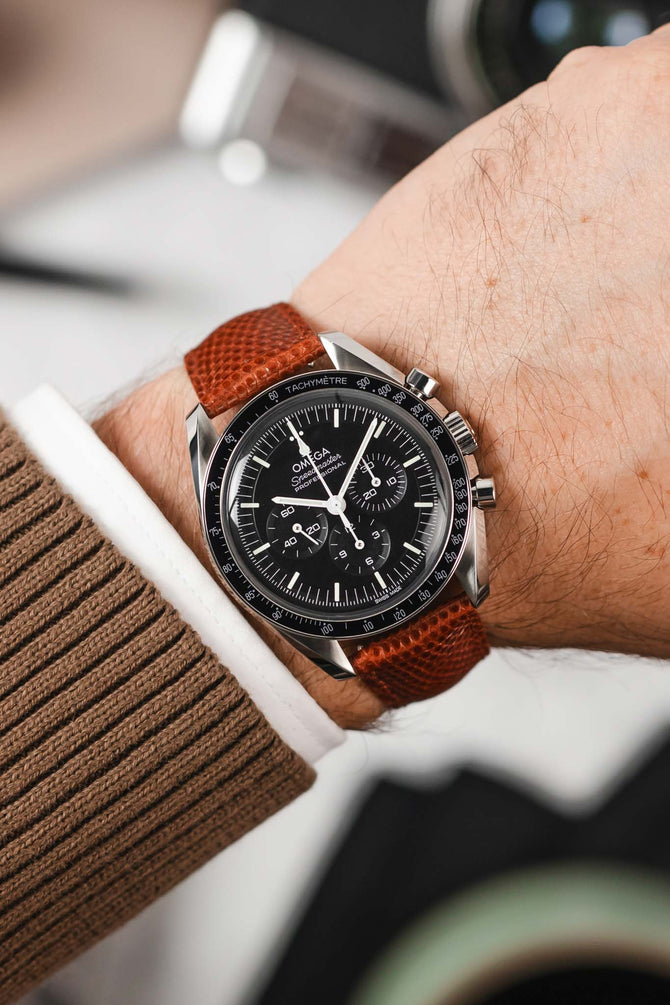 Black Omega Speedmaster Moonwatch fitted with Hirsch London Gold Brown lizard leather watch strap worn on wrist