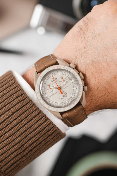 Omega Moonwatch Jupiter fitted with Hirsch London Alligator beige leather watch strap worn on wrist