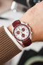 Omega Moonswatch Pluto fitted with Hirsch London Burgundy leather watch strap worn on wrist