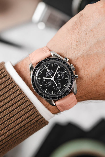 Black Omega Speedmaster moonwatch fitted with Hirsch London Alligator rosa leather watch strap worn on wrist