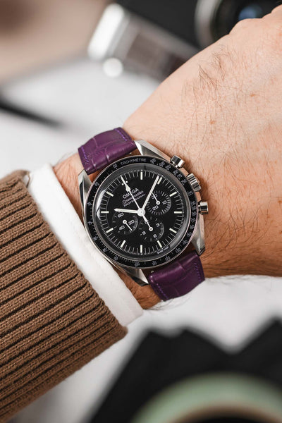Black Omega Speedmaster Moonwatch fitted with Hirsch London violet Alligator Leather watch strap worn on wrist