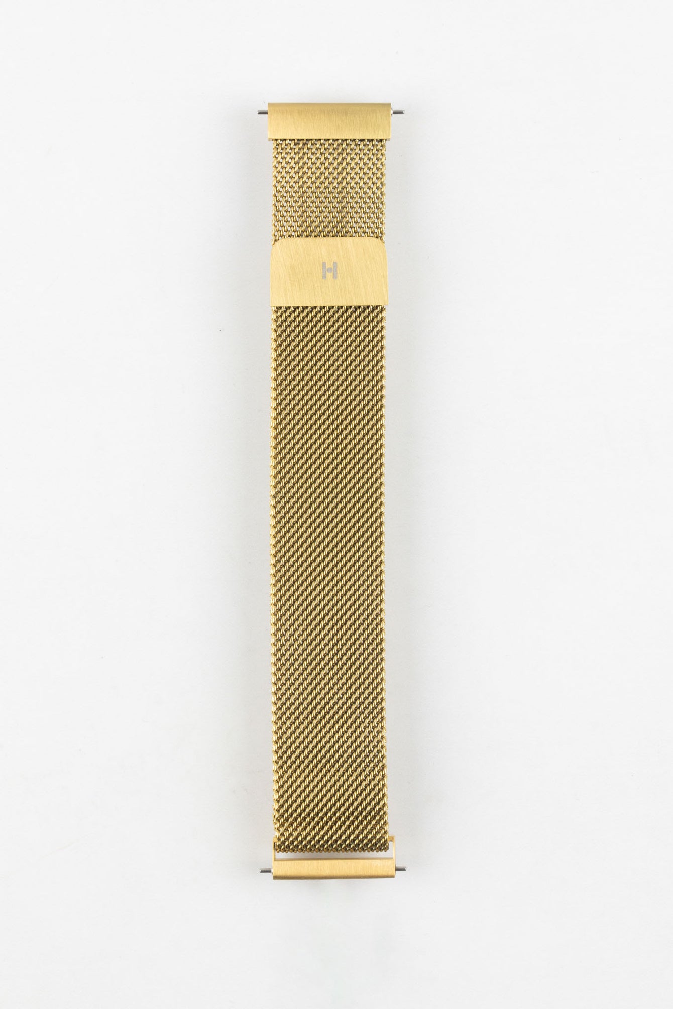 Product shot of a gold mesh watch strap displayed vertically against a white background, featuring a brushed gold adjustable sliding clasp with an engraved “H” logo, with the fine woven texture and integrated spring bars visible at both ends.
