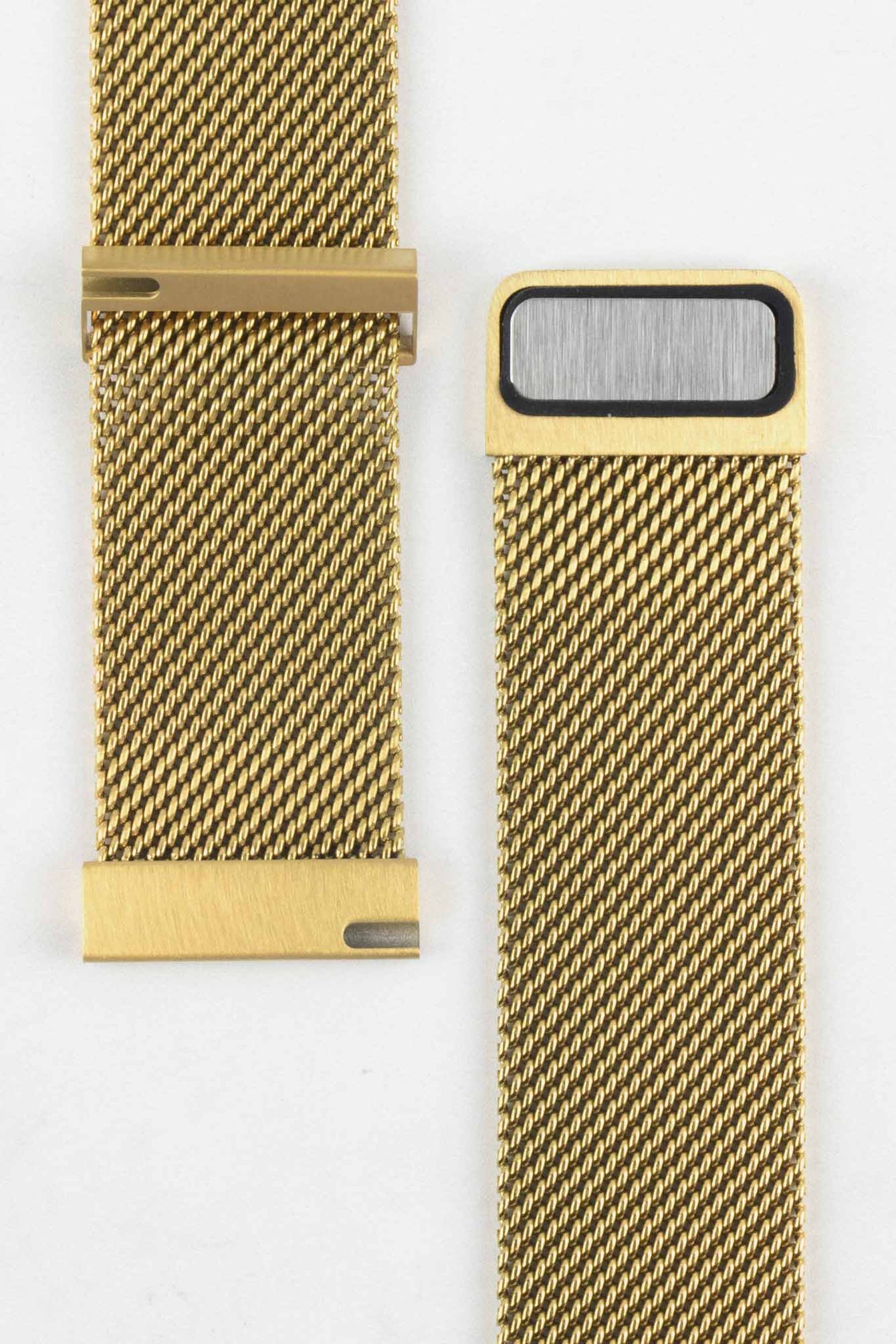 Close-up product image of a gold mesh watch strap against a white background, showing two separated sections with the clasp interior and attachment end visible, highlighting the fine woven texture and brushed gold hardware details.