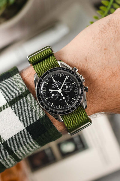 Omega Speedmaster fitted Green Nylon Watch Strap on wrist with check shirt