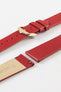 Close-up of a red leather watch strap displayed partially disassembled to showcase its integrated quick-release spring bars, smooth leather surface, matching red edge finishing, cream leather lining, and gold-tone pin buckle. The image highlights the strap’s premium craftsmanship, easy strap-change system, and classic styling against a clean white background.
