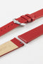 Close-up of a red leather watch strap displayed partially disassembled to showcase its integrated quick-release spring bars, smooth leather surface, matching red edge finishing, cream leather lining, and polished stainless steel pin buckle. The image highlights the strap’s premium craftsmanship, easy strap-change system, and clean contemporary styling against a white background.