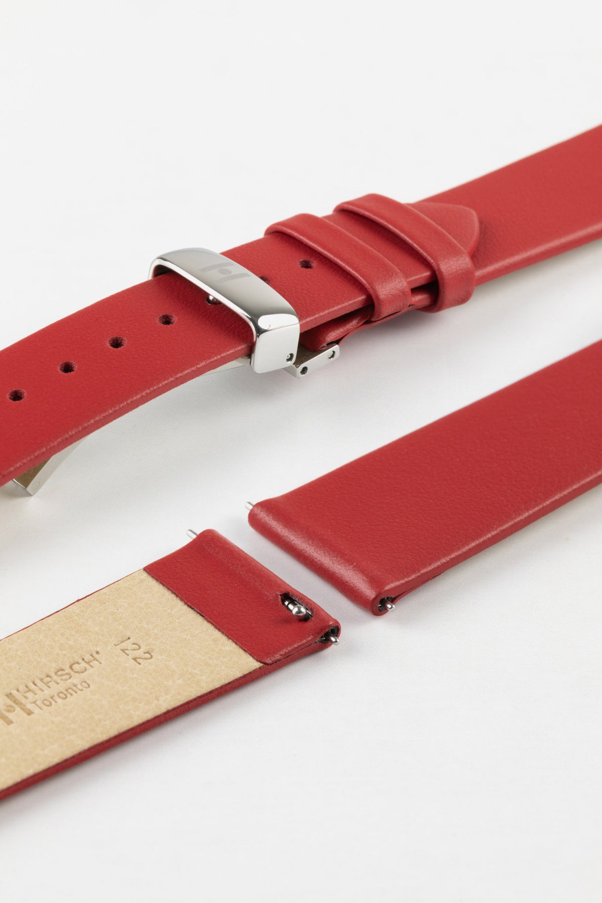 Close-up of a red leather watch strap displayed partially disassembled to showcase its integrated quick-release spring bars, cream leather lining, smooth leather surface, matching red edge finishing, and polished stainless steel buckle. The image highlights the strap’s easy-change mechanism, premium craftsmanship, and clean contemporary styling against a white background.