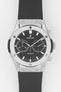 Close-up of a Hublot Classic Fusion chronograph with a black dial and subdials, set in a brushed steel case on a black rubber strap, shown against a clean white background.
