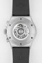 Close-up of the back of a Hublot Classic Fusion chronograph, showing the transparent caseback and automatic movement, with engraved “Hublot” and “Classic Fusion” on the titanium case and a black rubber strap.