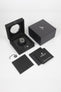 Studio shot of a Hublot Classic Fusion chronograph presented in its open black display box with branded packaging, warranty booklet, and accessories arranged on a white background.