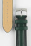 Close-up of a dark green leather watch strap on a light grey background, showing one section with a polished silver tang buckle featuring an engraved logo and two matching leather keepers. Beside it, the opposite strap section reveals the tan suede underside with a vertical row of evenly spaced adjustment holes. The leather has a smooth, slightly pebbled finish with light contrast stitching near the buckle, highlighting the strap’s construction.