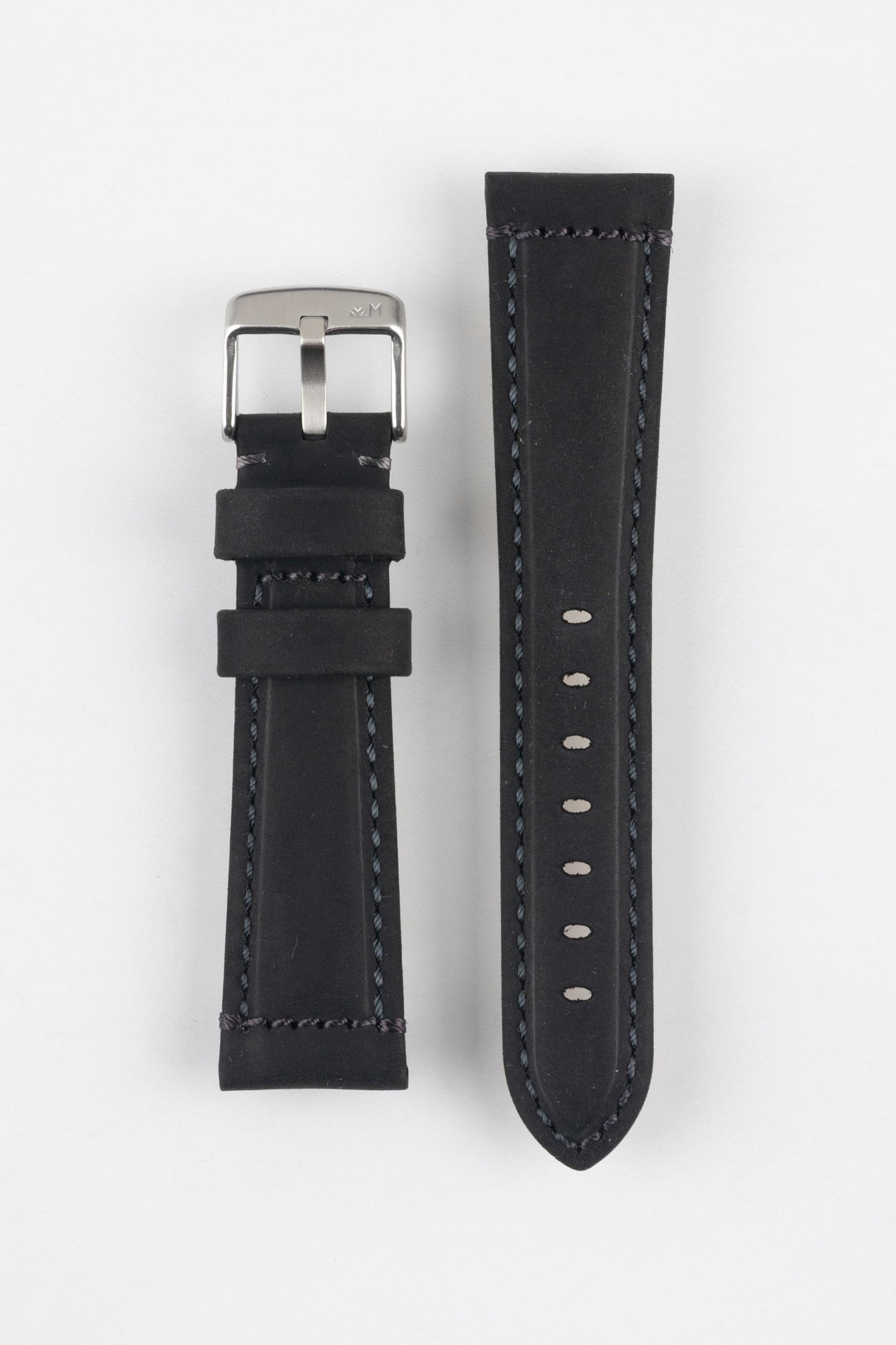 Two black leather watch strap pieces displayed vertically on a light grey background, featuring a matte, slightly textured finish with dark grey stitching. One strap section includes a brushed silver tang buckle with an engraved logo and two leather keepers, while the other shows a tapered end with a row of evenly spaced oval adjustment holes. The clean lines and stitched edges highlight the strap’s durable, contemporary design.