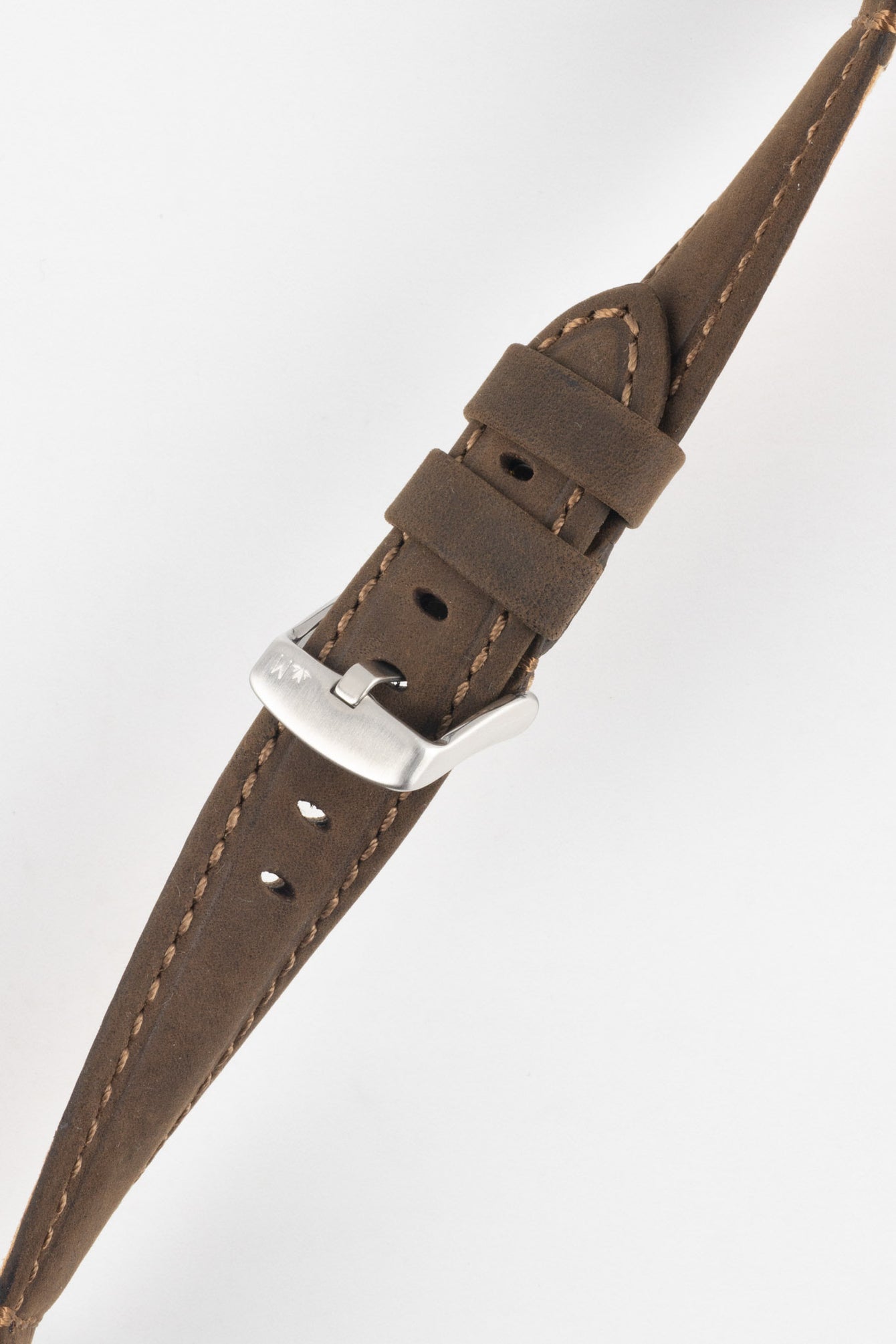 Brown leather watch strap with light stitching, shown in angled close-up with a silver buckle and adjustment holes.