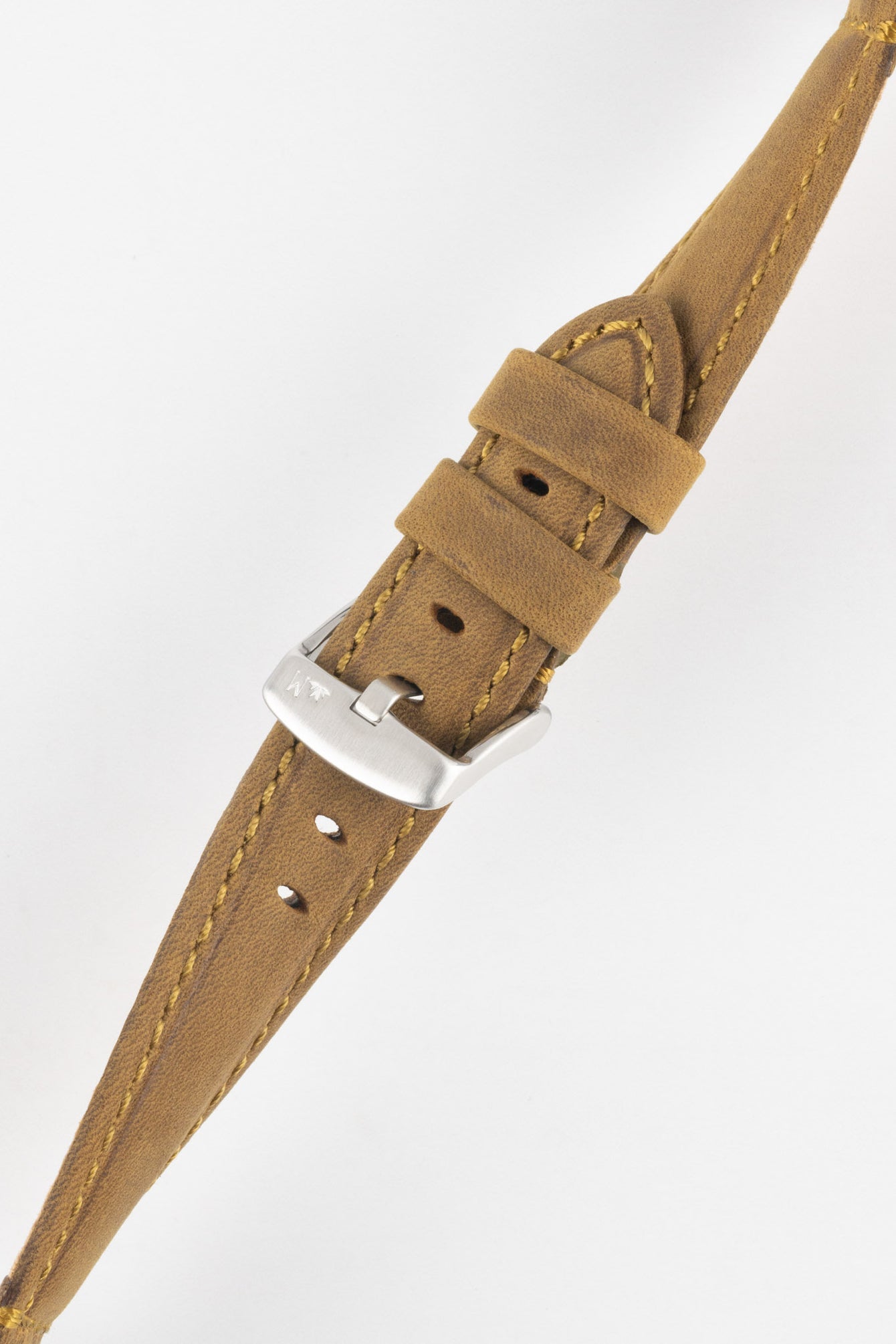 Tan-brown leather watch strap with yellow stitching, shown in angled close-up with a silver buckle and adjustment holes.