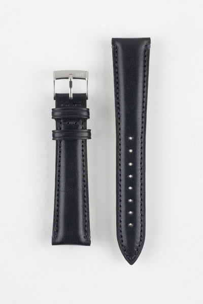Black leather watch strap with black stitching, shown vertically with a silver buckle and adjustment holes on a light grey background.