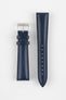 Blue leather watch strap with matching stitching, shown vertically with a silver buckle and adjustment holes on a light grey background.